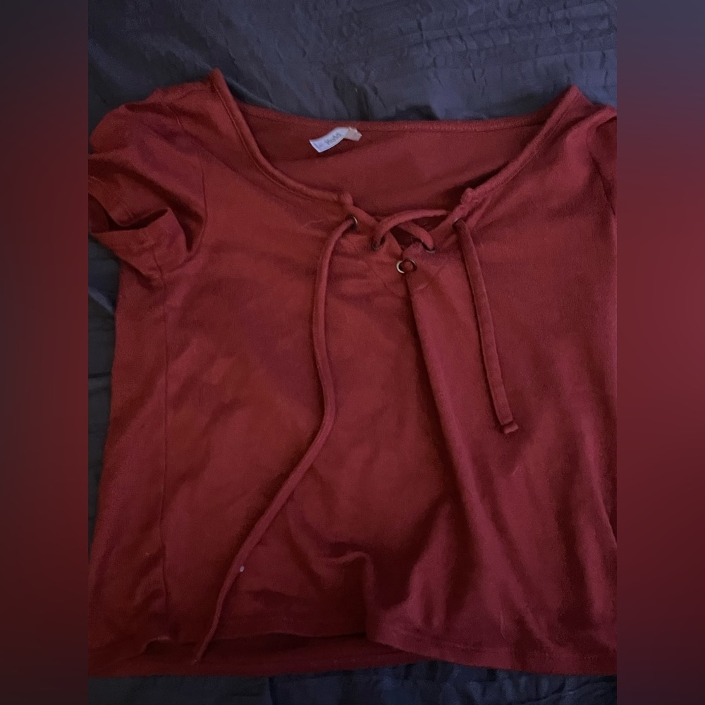 Orange-reddish t shirt with tie in the front. Very soft material. Hardly worn